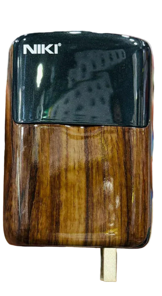 Hand holding a wooden-textured electronic device with 'NIKI' branding.