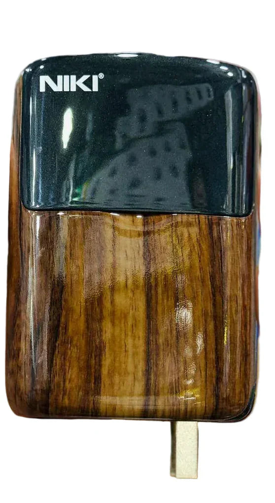 Hand holding a wooden-textured electronic device with 'NIKI' branding.
